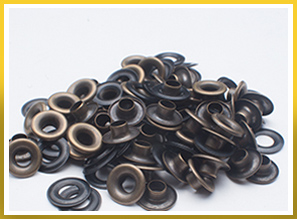 Close up image of scattered anique brass grommets