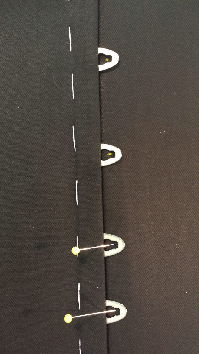 Both busk sides placed together, with the post positions marked on the fabric