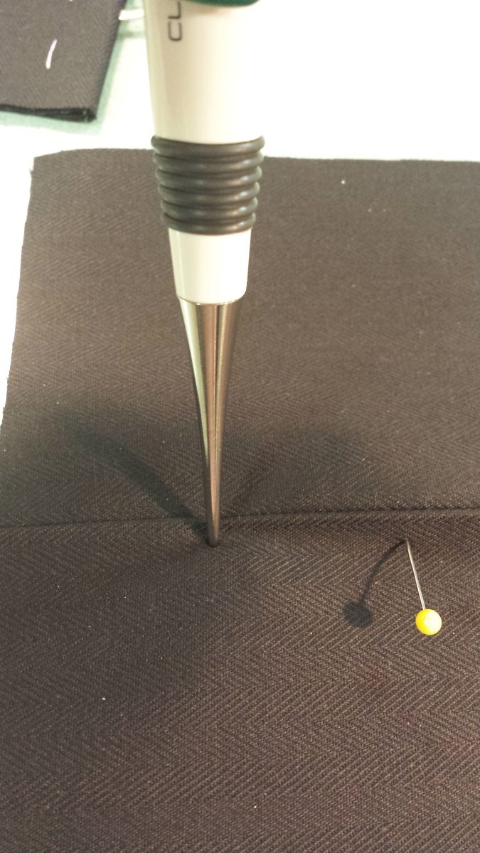 CorsetMaker's Awl opening a hole in the face fabric at a marked post position