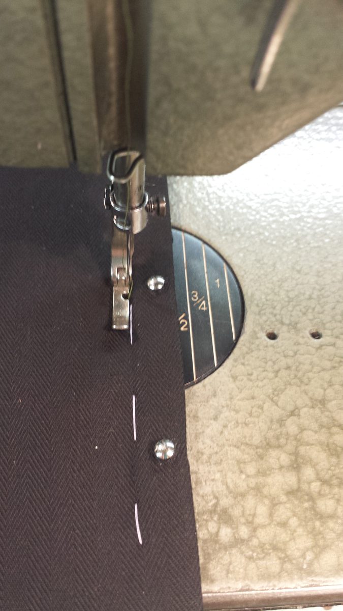 Stitching along the edge of the busk with a zipper foot