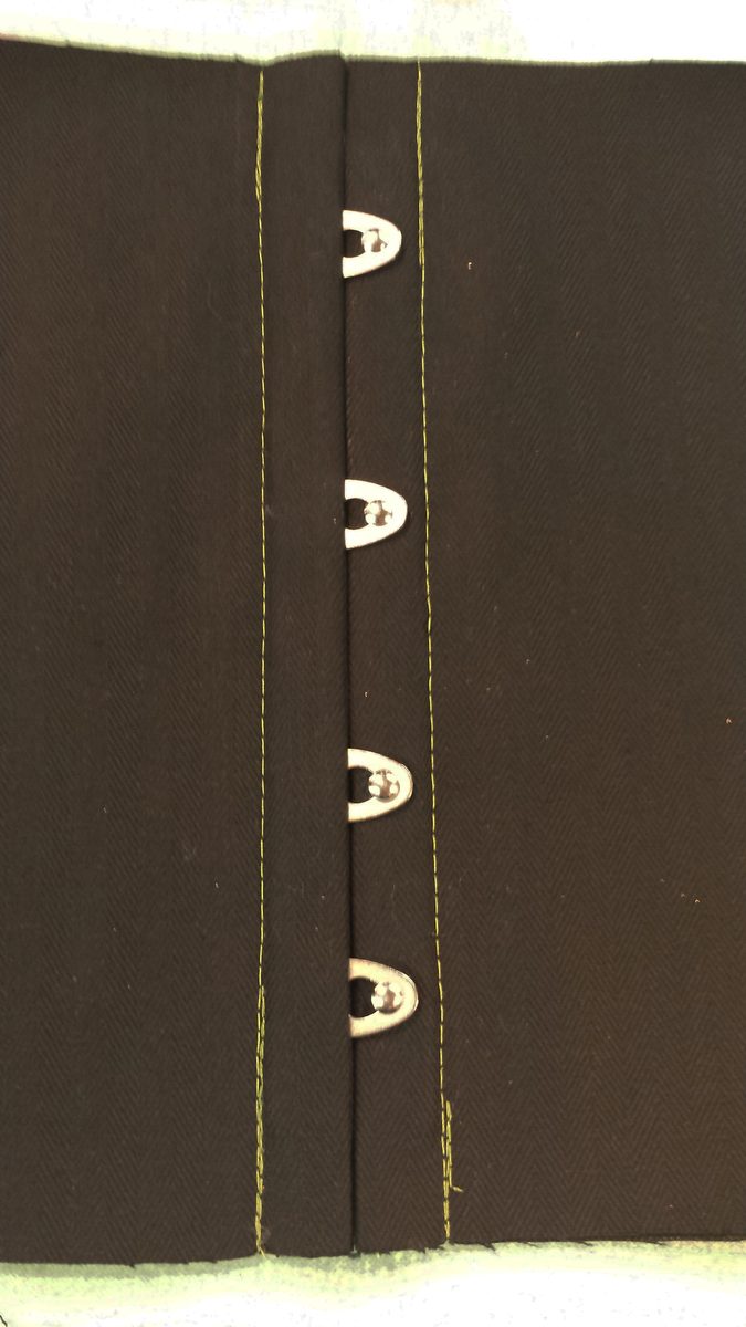 Finished busk set into the corset front, closed